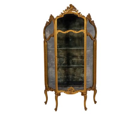 A contemporary carved giltwood vitirine in the French taste:, with foliate scroll and flowerhead cresting, having a plush lin