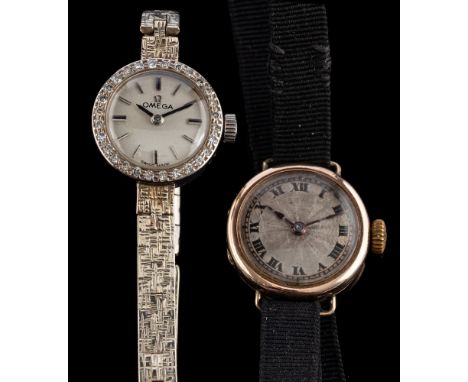 Omega, a gold and diamond wristwatch,: the dial with baton markers and black baton hands within a surround of eight cut diamo