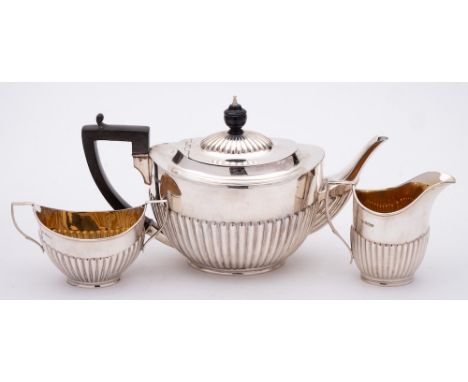 A George V silver three-piece tea service, maker William Hutton &amp; Sons Ltd, Sheffield, 1918: of oval outline with half re