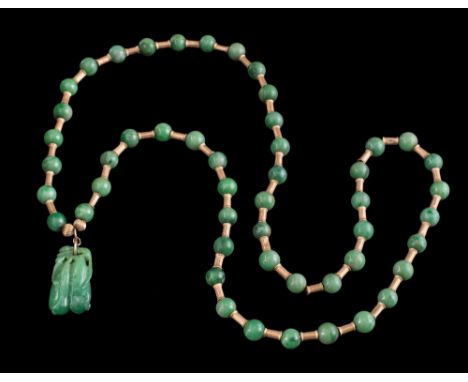 A carved jadeite pendant,:  carved in the form of two pea pods approximately 3cm long, suspended from a jade bead and cylindr