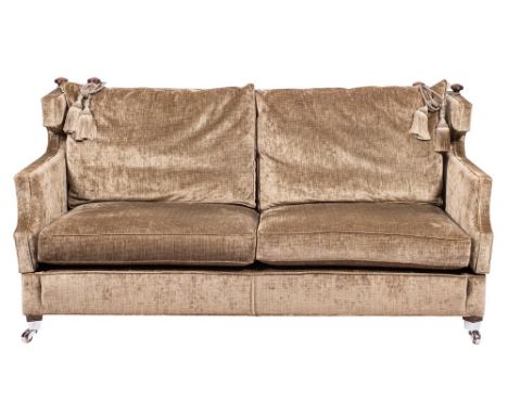 An upholstered Knole sofa by Bright's of Nettlebed, modern,: the drop ends with tasslled cords; the front legs with metal cap