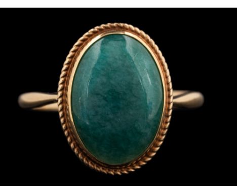 A 9 carat gold aventurine quartz ring,: the oval cabochon aventurine quartz in a collet setting, stamped 375 with full Birmin