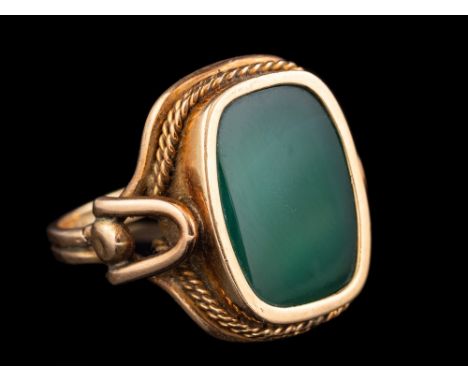 A dyed green agate ring,: the  agate panel in collet setting, with a ropetwist surround, ring size N