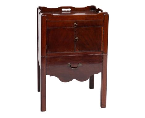A George III mahogany tray top commode:, the gallery with carrying handles, fitted with a small drawer, a pair of enclosing p