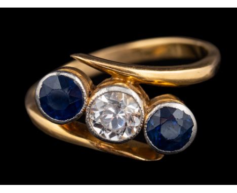 A sapphire and white sapphire ring,: the circular cut white sapphire collet set between two circular cut sapphires, ring size