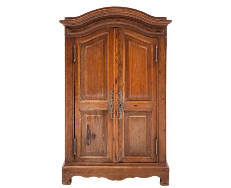 An Apprenticeman's beechwood armoire:, with a domed moulded cornice, enclosed by a pair of fielded panel doors, having a shap