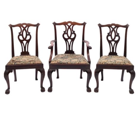 A set of eight 19th Century carved mahogany dining chairs in the Chippendale taste - including an elbow chair:, the backs wit