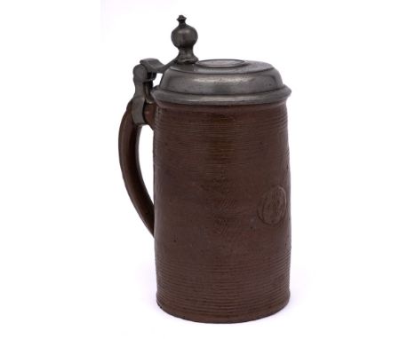 An early 18th century German pewter-mounted brown stoneware cylindrical tankard and a 19th century English stoneware shaving 