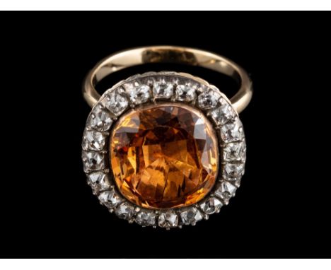 An orange topaz and diamond ring,: converted from a late 18th century brooch, the central cushion shaped orange topaz, in a c