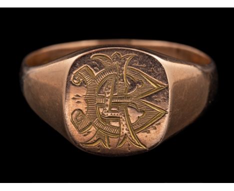 A 9 carat gold signet ring,: the panel engraved with a monogram, stamped 375 with full Birmingham hallmarks, ring size W, 6.8