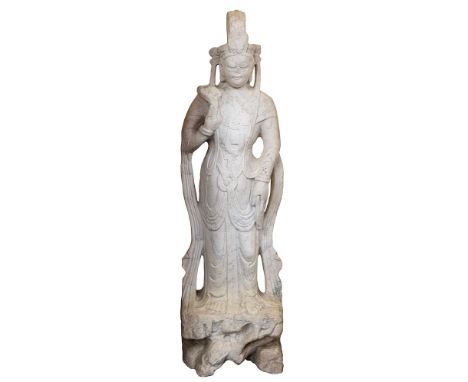 A large Chinese micaceous marble statue of Guanyin: in the Tang style, wearing traditional robes and headdress, holding a flo