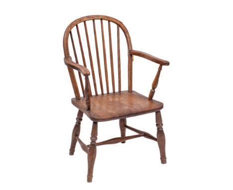 An early 19th Century elm, ash and beechwood stick back Windsor elbow chair:, with shaped arm supports and a shaped solid sea