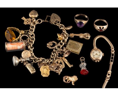 A charm bracelet,: the curb link chain with various charms, including a heart locket, a key, fobs, a car and others, stamped 