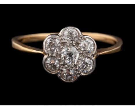 A 1920s diamond cluster ring,: set with old brilliant cut diamonds, approximately 0.42 carats total, ring size L 1/2.