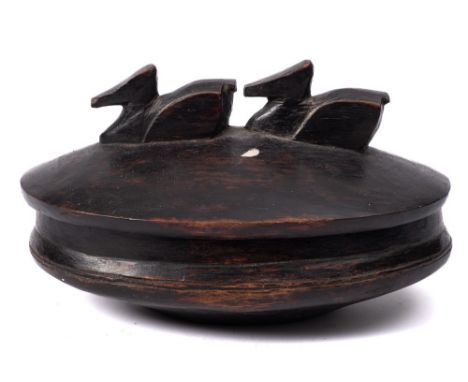 A carved wood oval bowl and cover, probably Polynesian: with finial in the form of two ducks, 29 x 18cm.