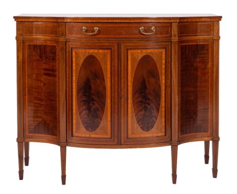 By Maple & Co LtdAn Edwardian mahogany and inlaid serpentine fronted display cabinet:, crossbanded in satinwood, bordered wit