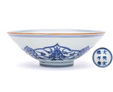 A Chinese blue and white 'lotus' bowl: of conical form, the interior painted with a medallion of a single lotus flower within