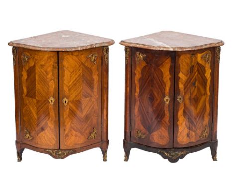 A matched pair of late 18th century French kingwood and gilt metal mounted serpentine fronted encoigneurs:, each surmounted b
