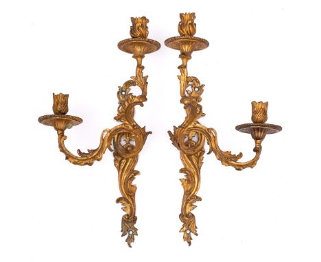 A pair of 19th century French gilt brass twin-light wall sconces: the urn-shaped sconces on scrolling branches issuing from a