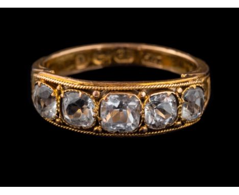 A 15 carat gold rock crystal ring,: set with five square cut rock crystals, between engraved shoulders, stamped 15 with Birmi