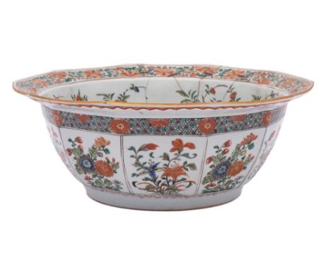 A Chinese famille verte decagonal bowl: finely enamelled overall with flowering shrubs and sprays, the interior with a flying