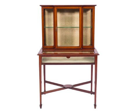 An Edwardian mahogany and inlaid display cabinet:, crossbanded in satinwood, bordered with boxwood and ebony lines, the break