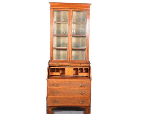 Edwardian inlaid mahogany cylinder rolltop desk, the top with three quarter gallery, the cylinder front with shell oval inlay