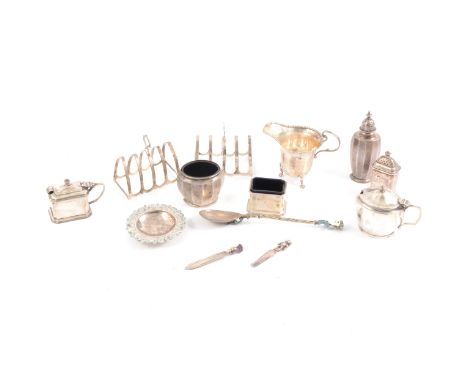 A pair of silver toast racks, Adie Brothers Ltd, Birmingham 1949, four sections; silver cream jug; silver three-piece cruets;