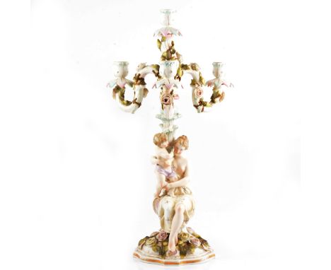 A Continental porcelain four-light candelabra, probably Jacob Petit, three encrusted branches, column designed with a mother 