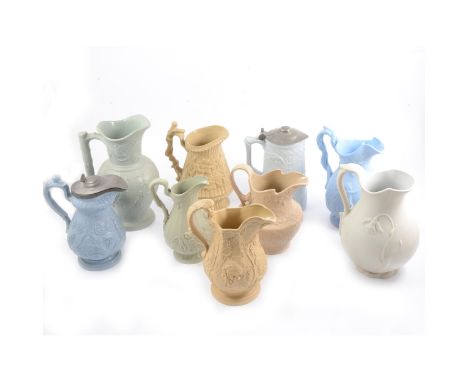 Nine assorted Victorian relief-moulded decorative jugs, including a Parian jug with snowdrop design, 20cm, a Brownfield 'Miss