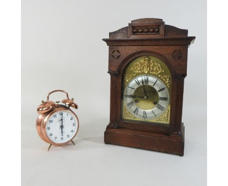 An early 20th century walnut bracket clock, 38cm high, together with a brass alarm clock