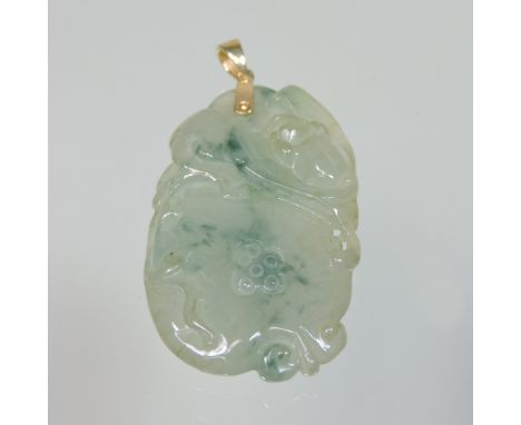A two colour carved jade pendant, of floral design, with an 18 carat gold mount, 4cm high