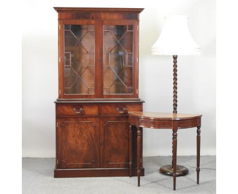 A mahogany cabinet bookcase, 103cm, together with a console table and a standard lamp (3)