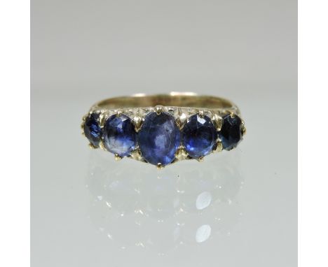 An unmarked gold five stone sapphire ring