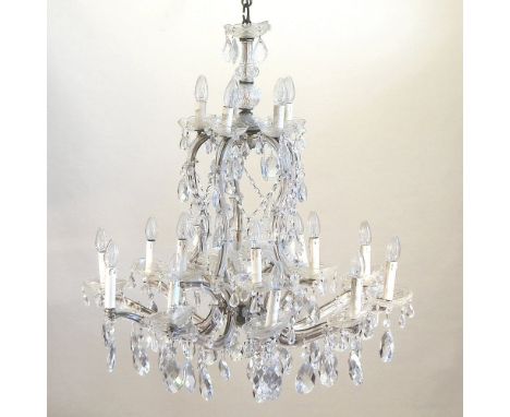 An early 20th century French cut crystal chandelier, having ten branches and suspended with cut glass drops, 100cm high