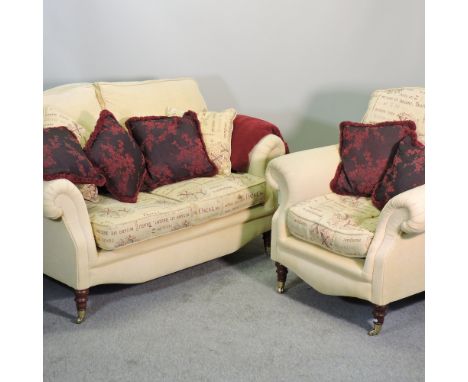 A yellow upholstered two seater sofa, on turned legs, 160cm, with cushions, together with a matching armchair