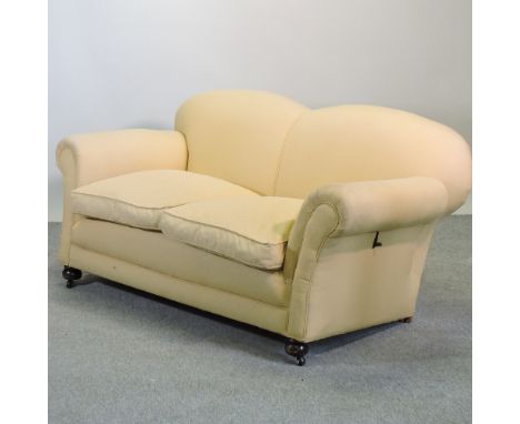 A 1920's gold upholstered drop-end sofa, on bun feet, 168cm