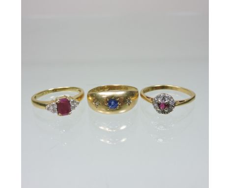 An 18 carat gold sapphire and diamond gypsy ring, together with two 18 carat gold ruby rings (3)