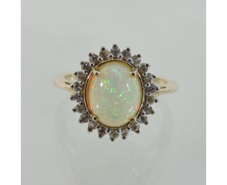 A 14 carat gold opal and diamond cluster ring