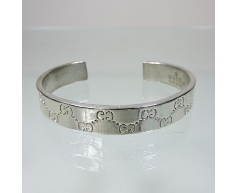 A Gucci silver bangle, with interlaced G monograms, marked 925, boxed