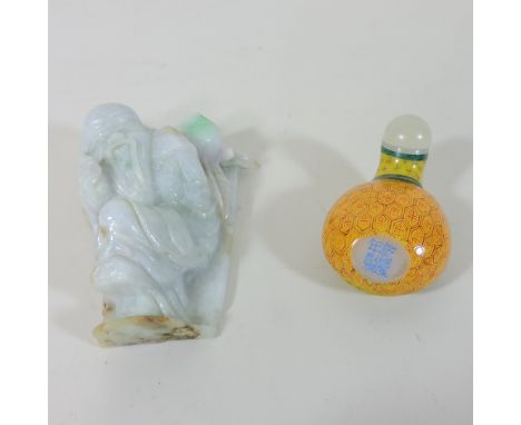 A lavender jade style carving of an oriental figure, 9.5cm high, together with a modern Chinese snuff bottle, boxed
