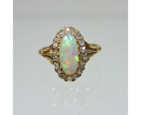 An 18 carat gold opal and diamond cluster ring