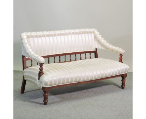 An Edwardian cream upholstered and spindle back show frame sofa, 133cm