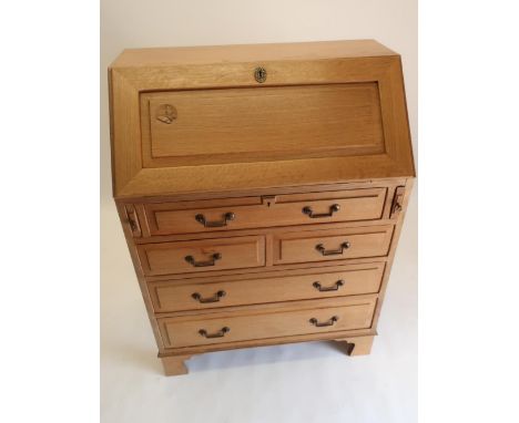 Andrew Conning Butterfly Furniture - an oak bureau, panelled fall front with fitted interior above one long, two short and tw