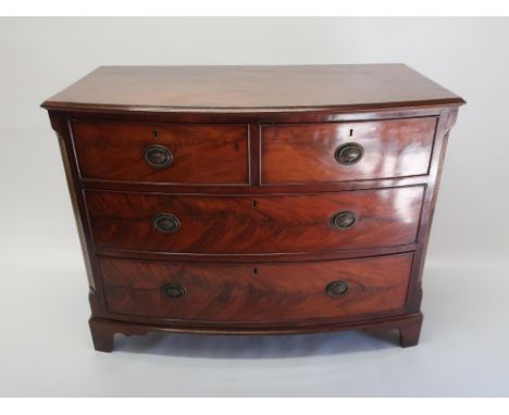 Victorian bow front mahogany chest of two short and two long drawers with brass laurel wreath handles, enclosed by fluted can