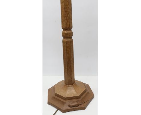 Robert Mouseman Thompson - an oak standard lamp, adzed octagonal tapering column on stepped base, carved with signature mouse