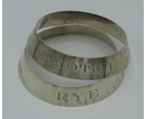 Pair of Geo.V1 hallmarked silver bottle neck rings, engraved Scotch and Rye, London 1937 by Harman &amp; Co, D7cm (2) 