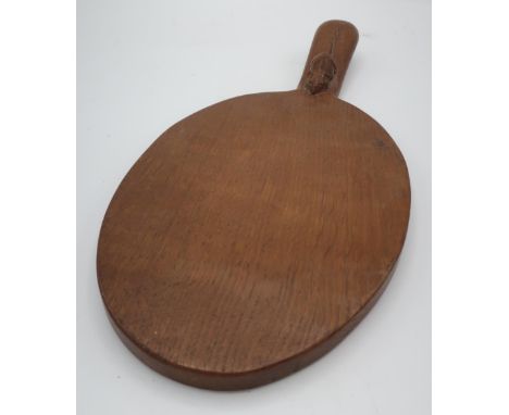 Robert Mouseman Thompson - an adzed oak oval cheeseboard, handle carved with signature mouse L37cm 