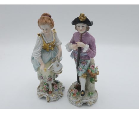 Pair of 20th century Sitzendorf porcelain figures of lady and gentleman gardeners, each wearing 18th Century costume on scrol