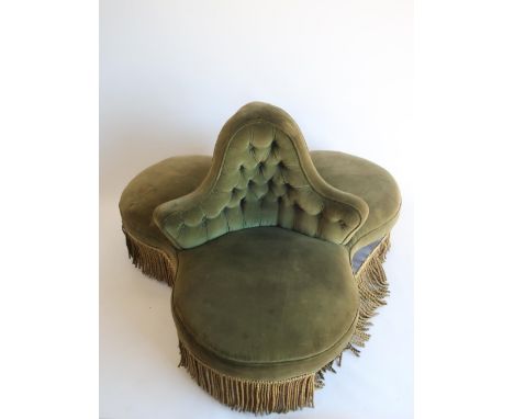 Victorian three seat conversation sofa, with deep buttoned back and heavy fringed frieze on turned walnut supports, with bras